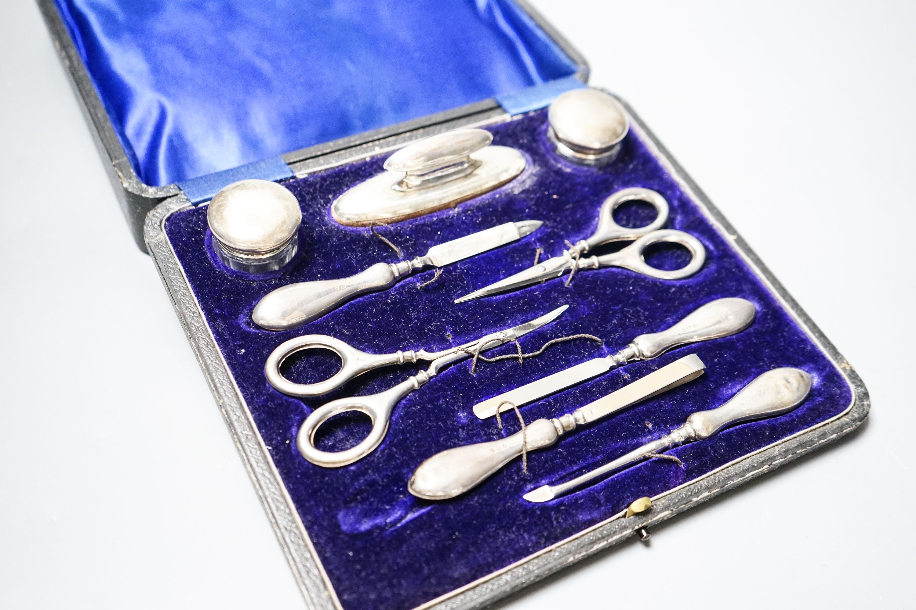 A cased silver mounted nine piece manicure set.